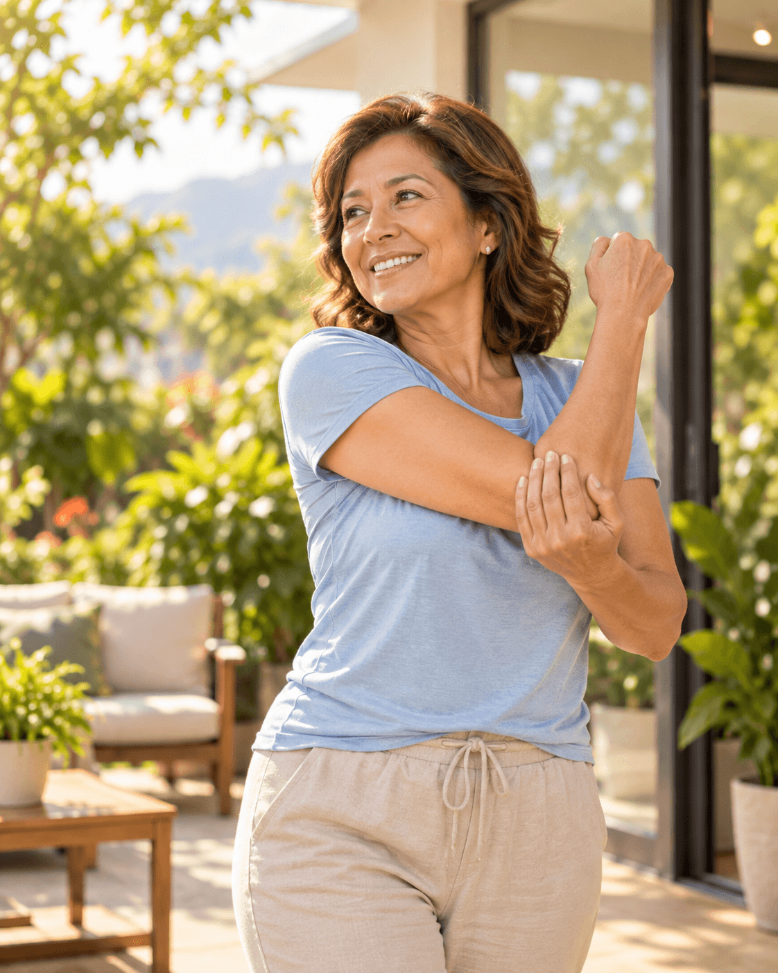 Woman stretching her arm on a sunny patio at home